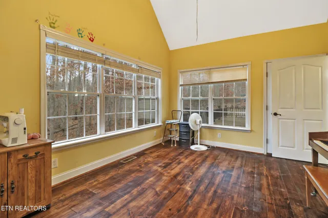 a bathroom with a toilet a sink a mirror a vanity and shower