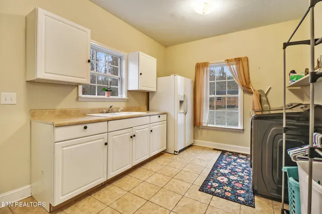 a view of a room with wooden floor and a ceiling fan