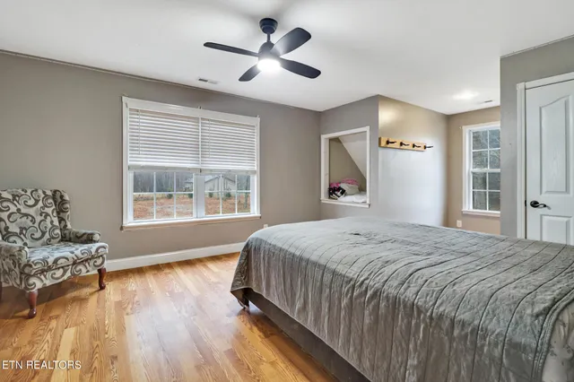 a bedroom with a bed and a ceiling fan