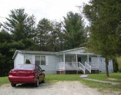3636 North Fork Road Elliston, VA 24087 - Photo 1 of 1 a front view of a house with a garden and trees