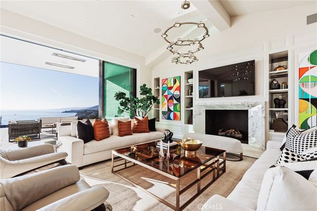 a living room with furniture a flat screen tv and a fireplace