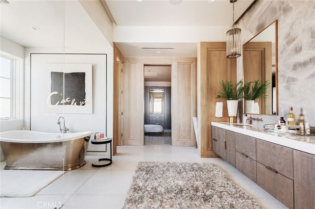 a bathroom with a tub sink and mirror