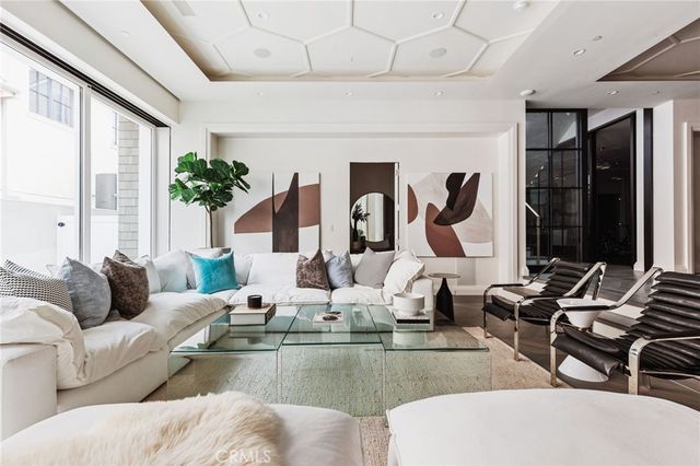 a living room with furniture and large windows