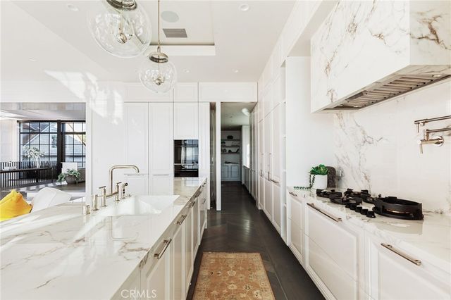 a kitchen with stainless steel appliances a sink stove and cabinets