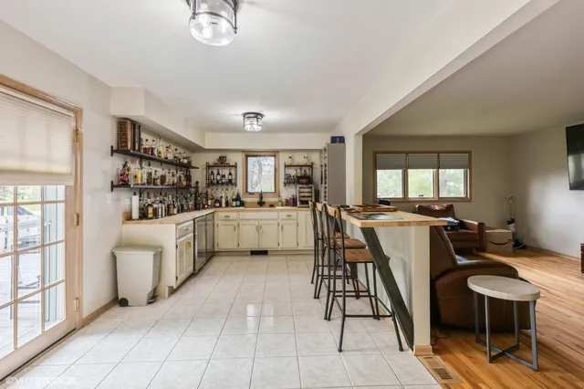 a kitchen with a dining table chairs and white appliances