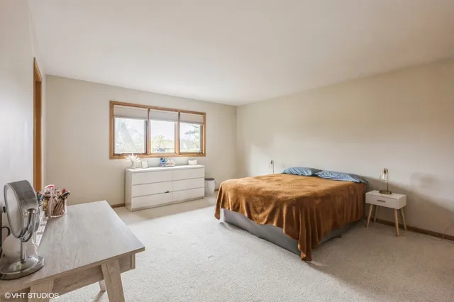 a bedroom with a bed and a table in it