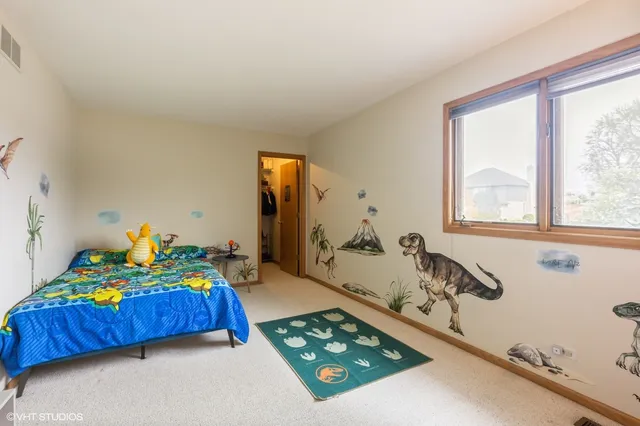 a bedroom with a bed and a dresser