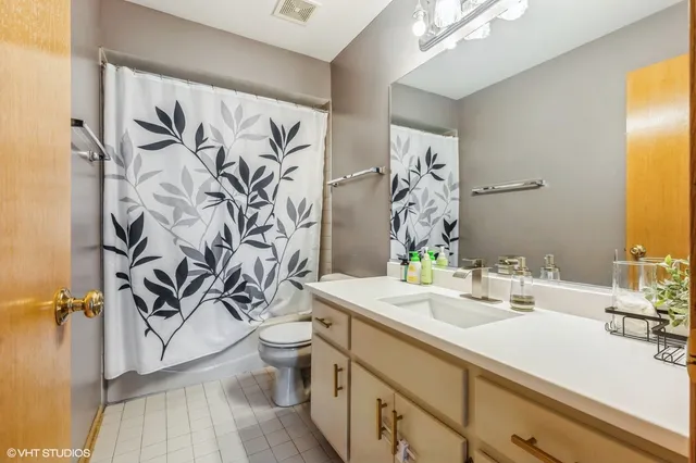 a bathroom with a sink and mirror with toilet