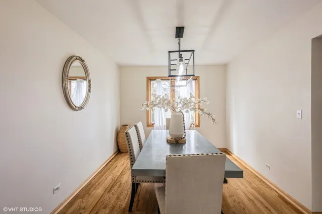 a dining room with furniture and a window
