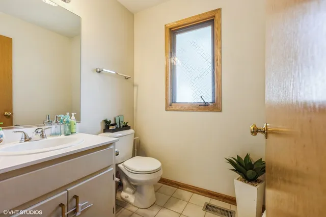 a bathroom with a toilet a sink and mirror
