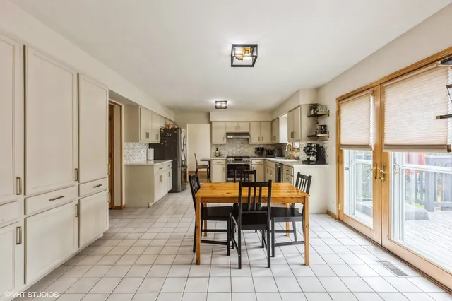 a dining room with furniture and a kitchen view