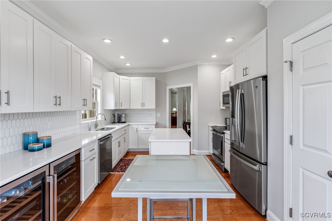 5060 Park Commons Loop Glen Allen, VA 23059 - Photo 11 of 38 a large kitchen with stainless steel appliances granite countertop a refrigerator a sink dishwasher a stove and white cabinets with wooden floor