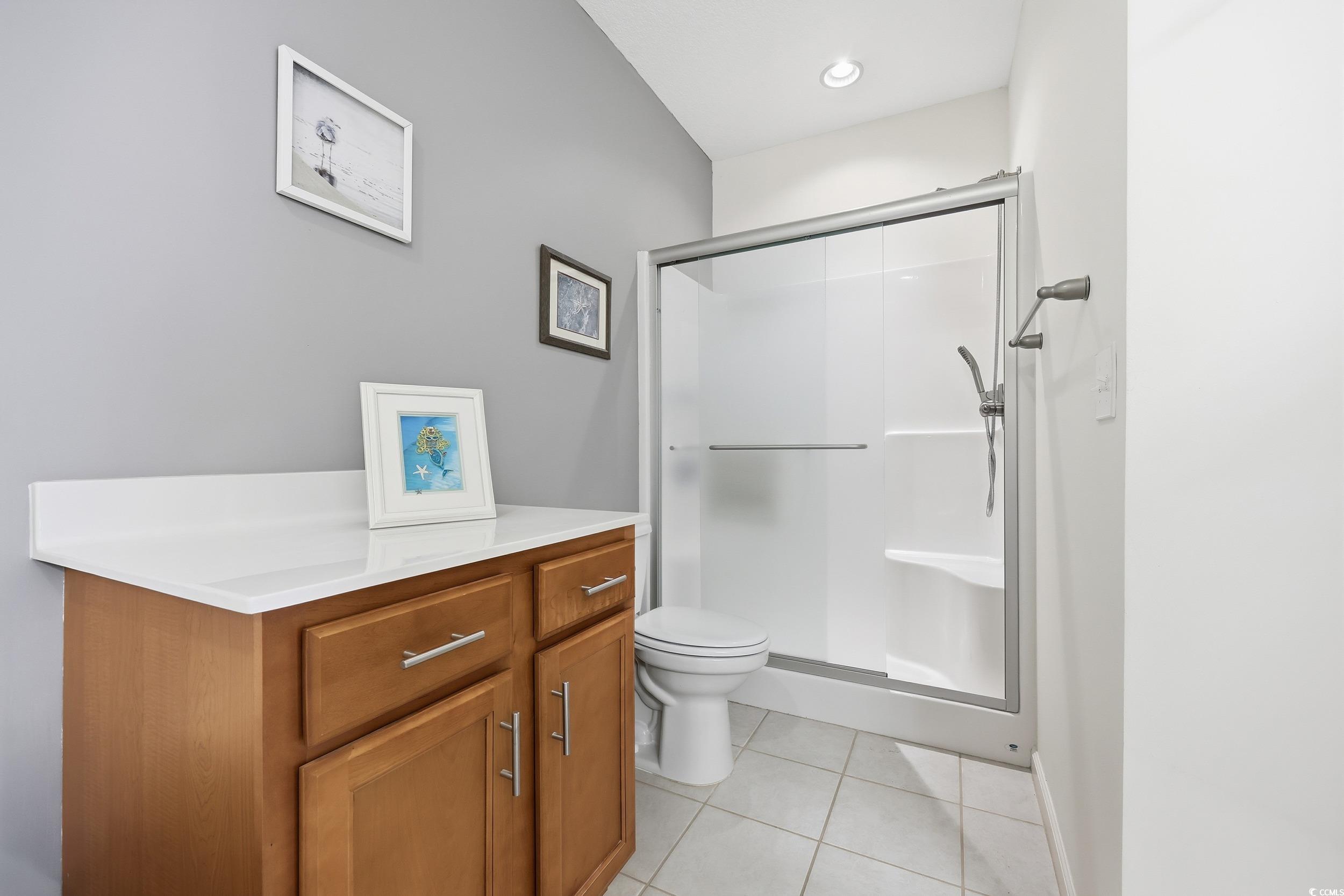 822 Sail Lane, Unit 103 Murrells Inlet, SC 29576 - Photo 22 of 37 Primary Bathroom featuring double vanity, a garden tub, light tile patterned floors, and a walk in shower