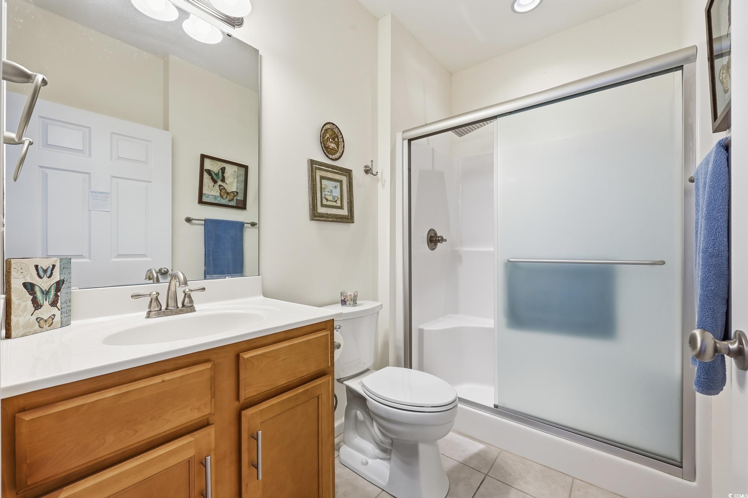 822 Sail Lane, Unit 103 Murrells Inlet, SC 29576 - Photo 23 of 37 Full bath featuring vanity, a shower stall, and light tile patterned flooring