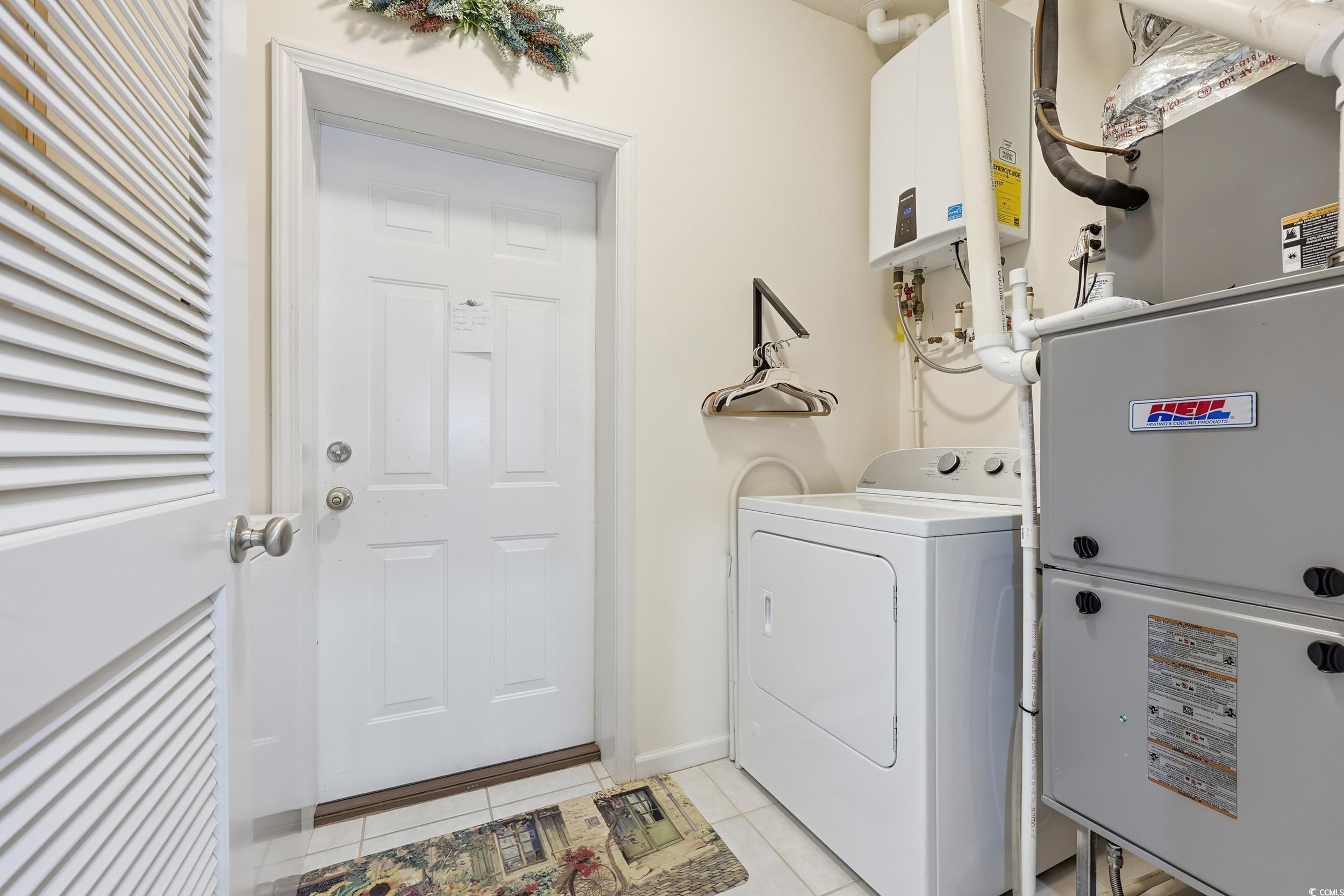 822 Sail Lane, Unit 103 Murrells Inlet, SC 29576 - Photo 24 of 37 Laundry room with washer / clothes dryer, heating unit, and light tile patterned floors