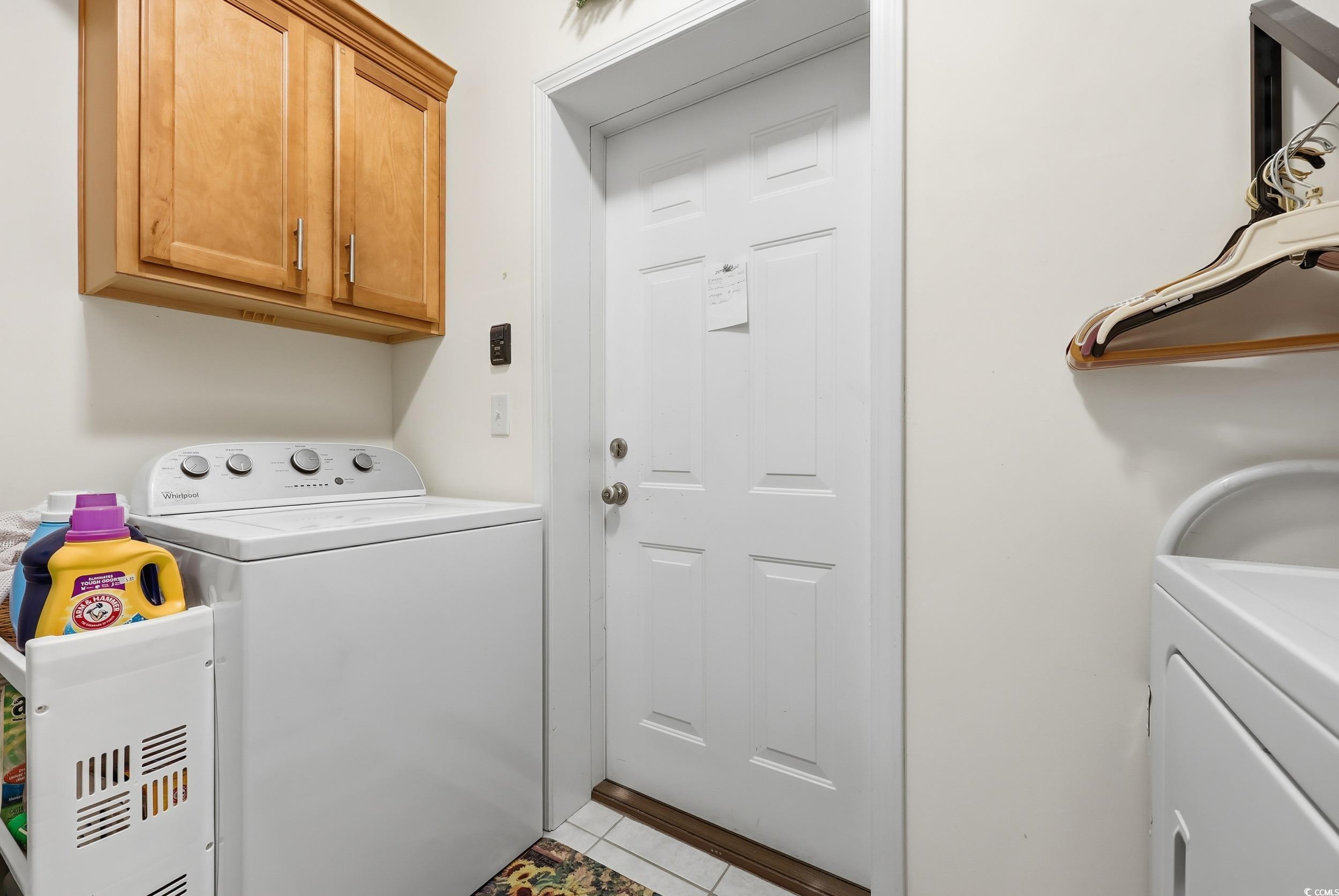 822 Sail Lane, Unit 103 Murrells Inlet, SC 29576 - Photo 25 of 37 Laundry room with light tile patterned floors, separate washer and dryer, and cabinet space