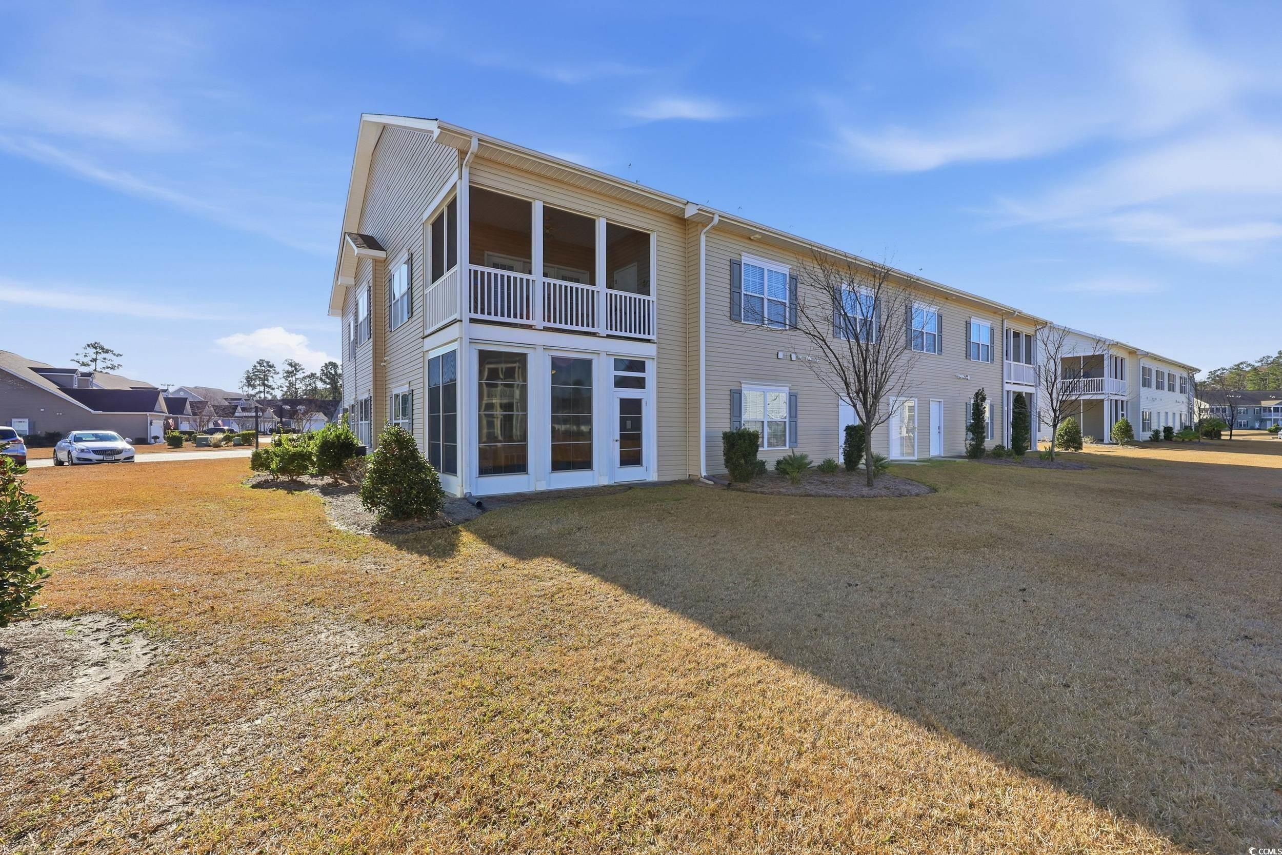 822 Sail Lane, Unit 103 Murrells Inlet, SC 29576 - Photo 29 of 37 Back of property featuring a sunroom and a lawn