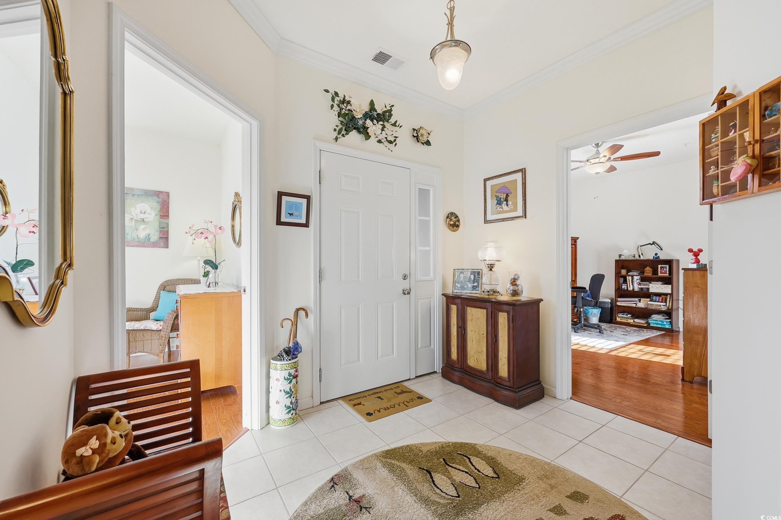 822 Sail Lane, Unit 103 Murrells Inlet, SC 29576 - Photo 4 of 37 Entryway featuring light tile patterned floors, crown molding, and a ceiling fan