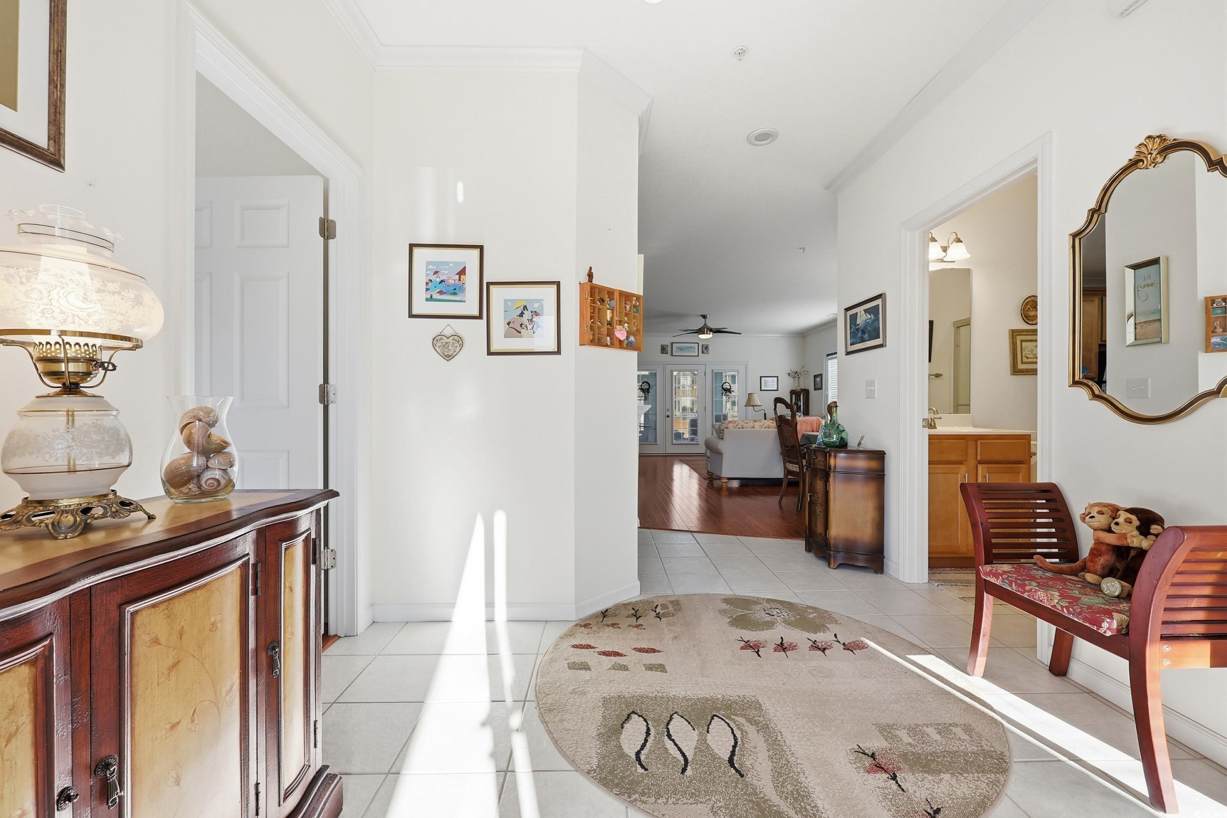 822 Sail Lane, Unit 103 Murrells Inlet, SC 29576 - Photo 5 of 37 Hallway featuring light tile patterned floors and ornamental molding