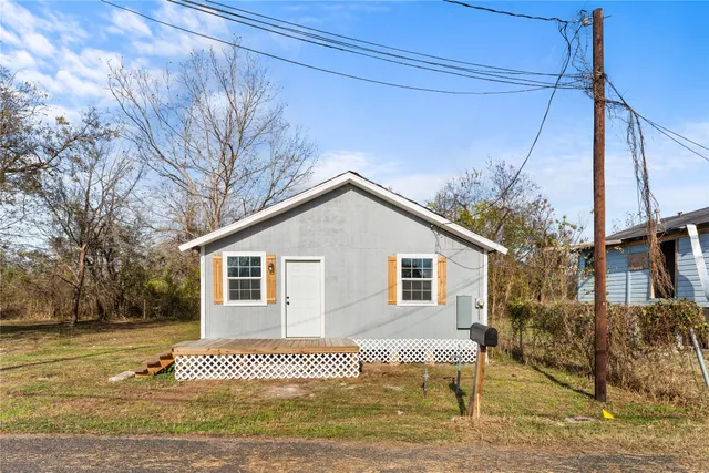 a view of a house with a yard and fence