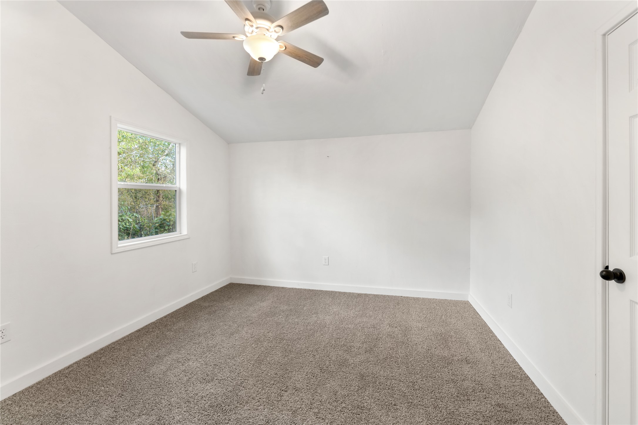 1608 Connie Street Wharton, TX 77488 - Photo 12 of 24 an empty room with a window and a fan