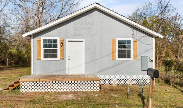 a front view of a house with a garden