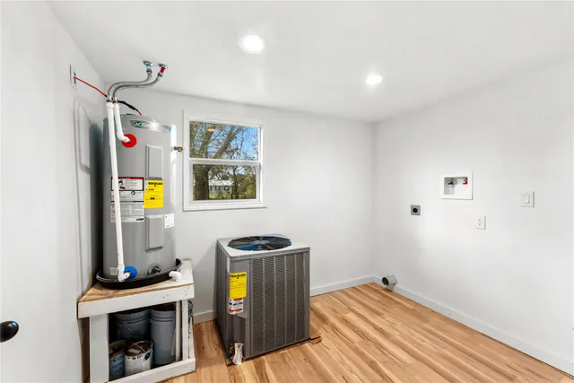 a view of a livingroom with wooden floor and furniture