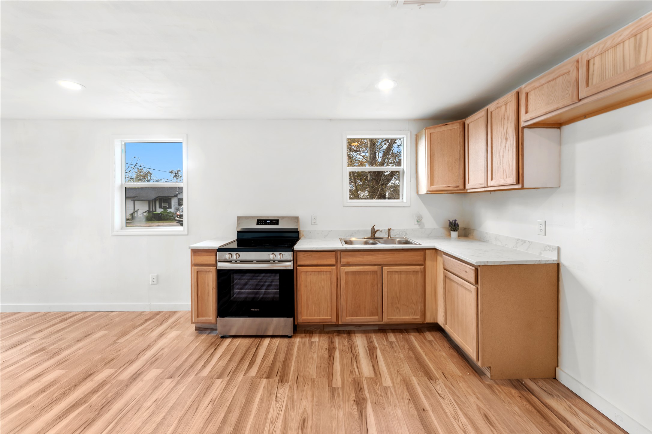 1608 Connie Street Wharton, TX 77488 - Photo 5 of 24 a kitchen with wooden floors and white appliances