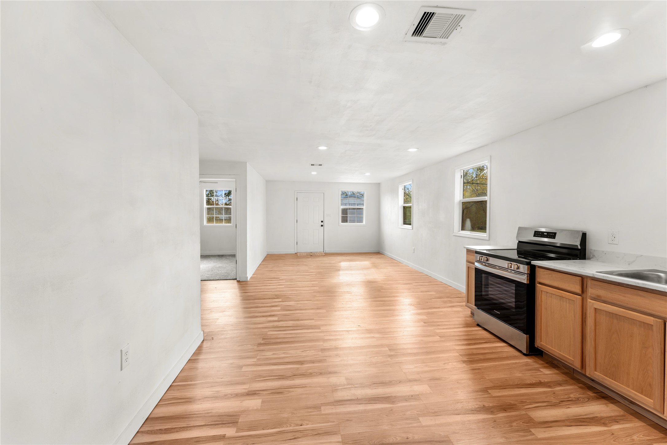 1608 Connie Street Wharton, TX 77488 - Photo 6 of 24 a large kitchen with stainless steel appliances granite countertop a stove and a wooden floors