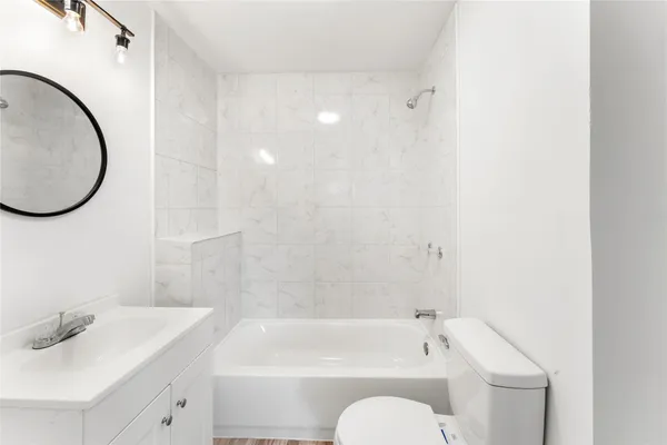 a bathroom with a sink a toilet and a bathtub