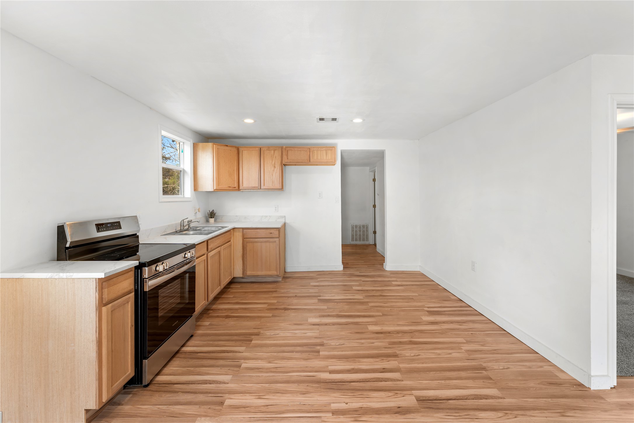 1608 Connie Street Wharton, TX 77488 - Photo 9 of 24 a large kitchen with stainless steel appliances granite countertop a stove a sink and a refrigerator