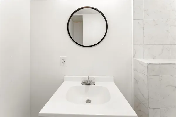 a bathroom with a sink and a mirror