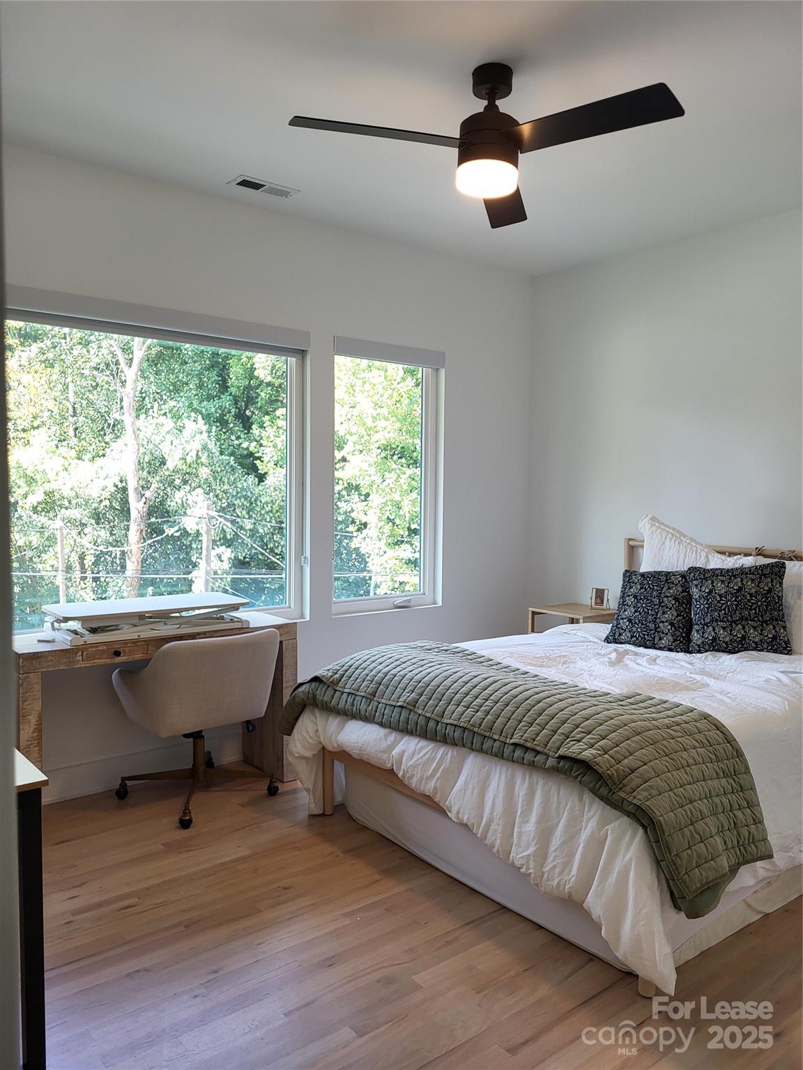 1932 St Mark Street Charlotte, NC 28216 - Photo 17 of 23 a bedroom with a bed and a chandelier