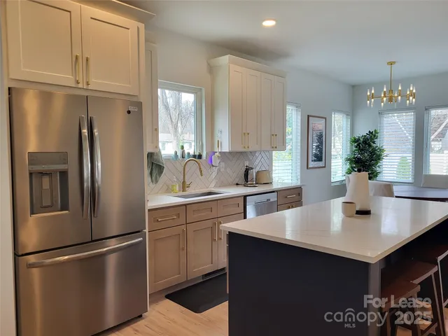 a kitchen with stainless steel appliances a sink and cabinets