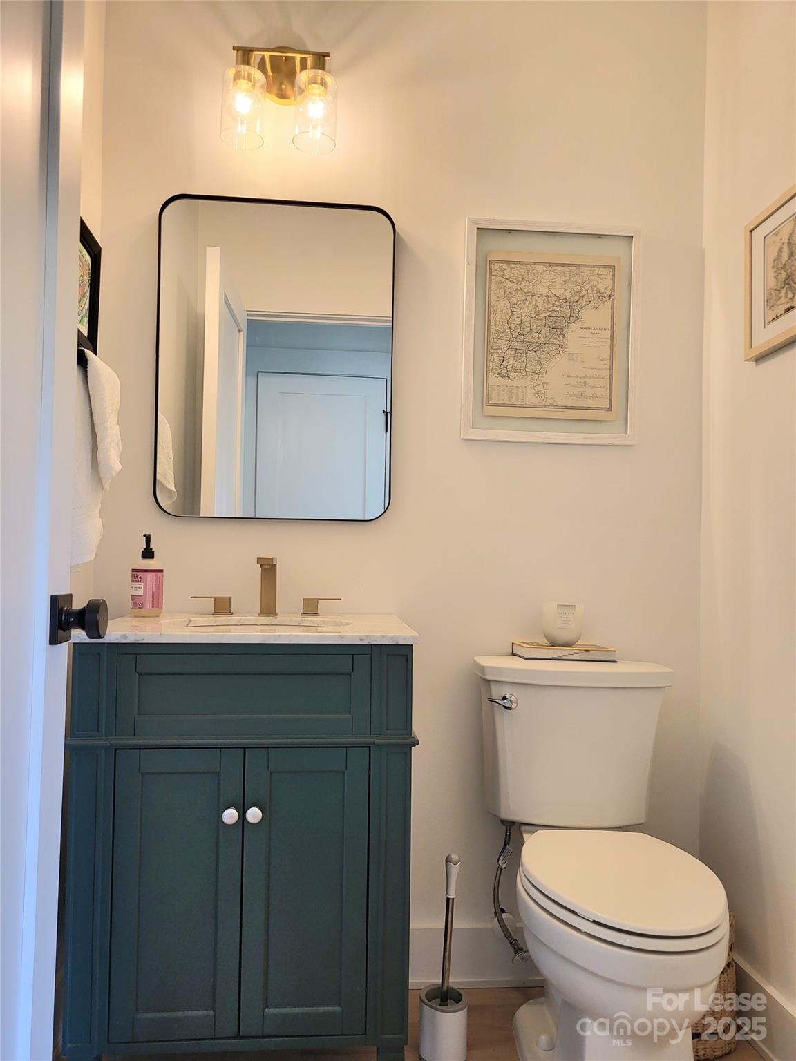 1932 St Mark Street Charlotte, NC 28216 - Photo 10 of 23 a bathroom with a toilet sink vanity and mirror
