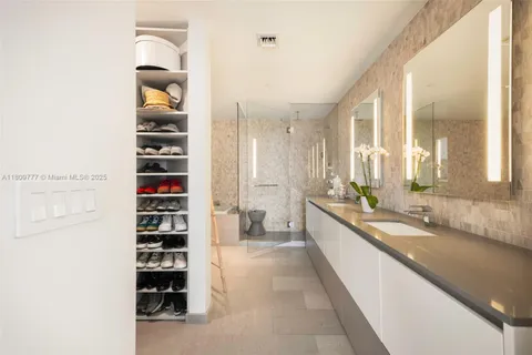 a large white room with a large window and cabinets