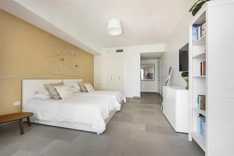 a bedroom with a bed and a couch