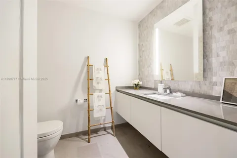 a bathroom with a double vanity sink toilet and shower