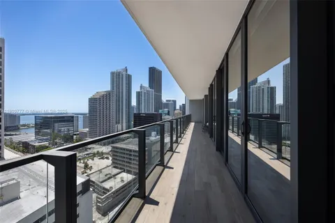 a view of balcony with two chairs and wooden floor