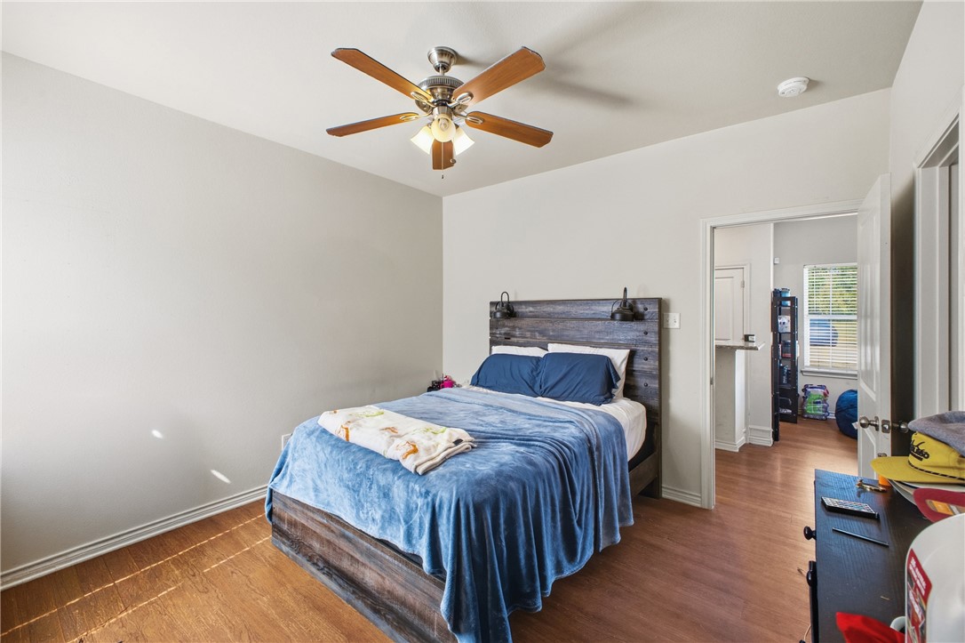 4400 Milam Street Bryan, TX 77801 - Photo 10 of 25 a bedroom with a bed and a chandelier