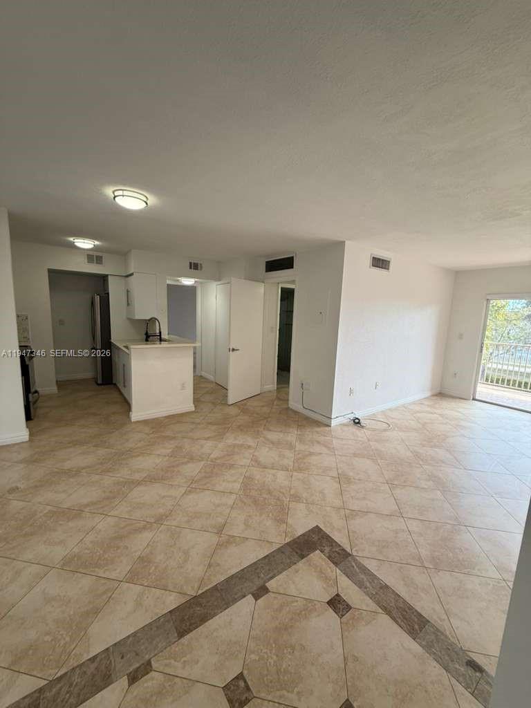 15221 Southwest 80th Street, Unit 313 Miami, FL 33193 - Photo 11 of 19 a view of a big room with closet and windows