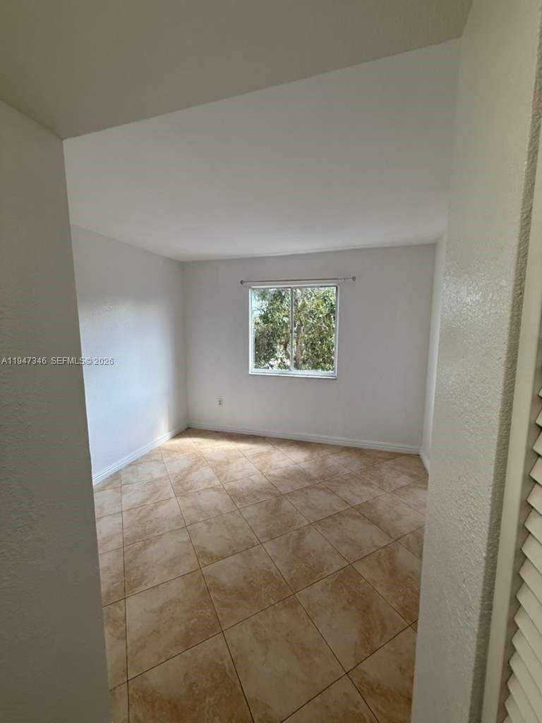 15221 Southwest 80th Street, Unit 313 Miami, FL 33193 - Photo 12 of 19 an empty room with windows