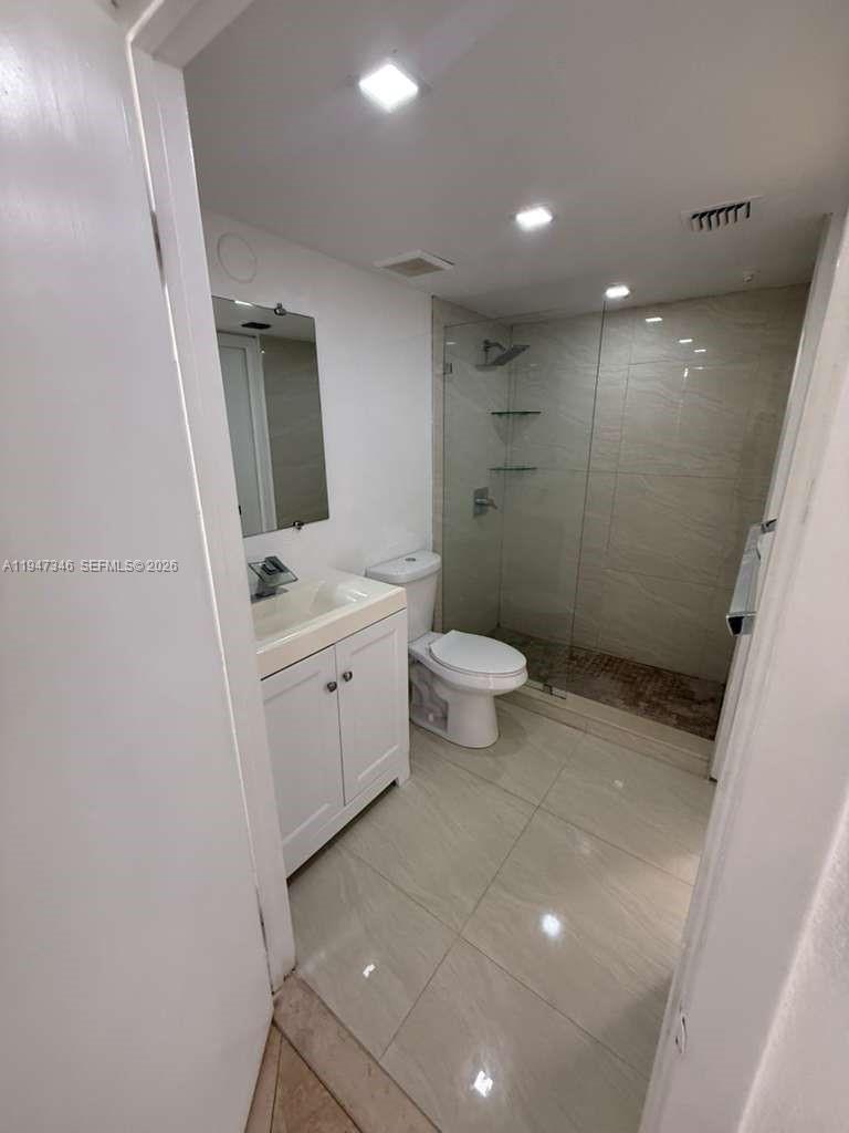 15221 Southwest 80th Street, Unit 313 Miami, FL 33193 - Photo 13 of 19 a bathroom with a sink a toilet a mirror and shower