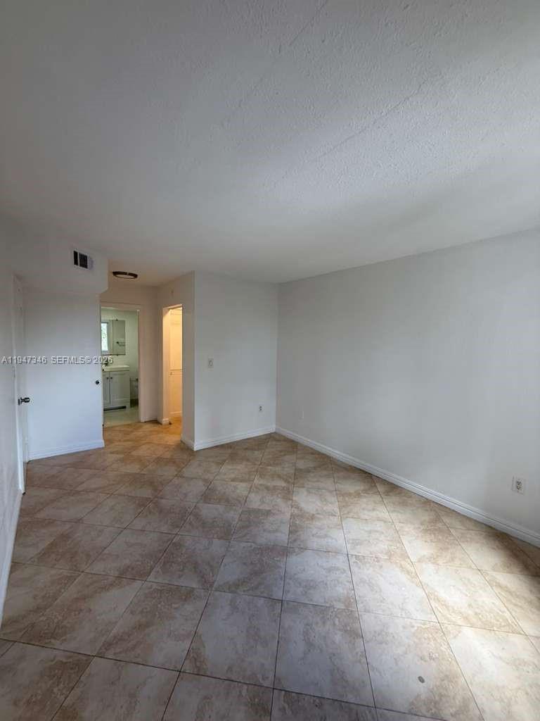 15221 Southwest 80th Street, Unit 313 Miami, FL 33193 - Photo 15 of 19 a view of an empty room with window and fireplace