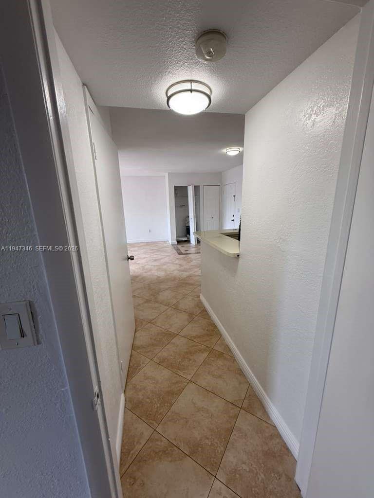 15221 Southwest 80th Street, Unit 313 Miami, FL 33193 - Photo 16 of 19 a view of a hallway to a bedroom