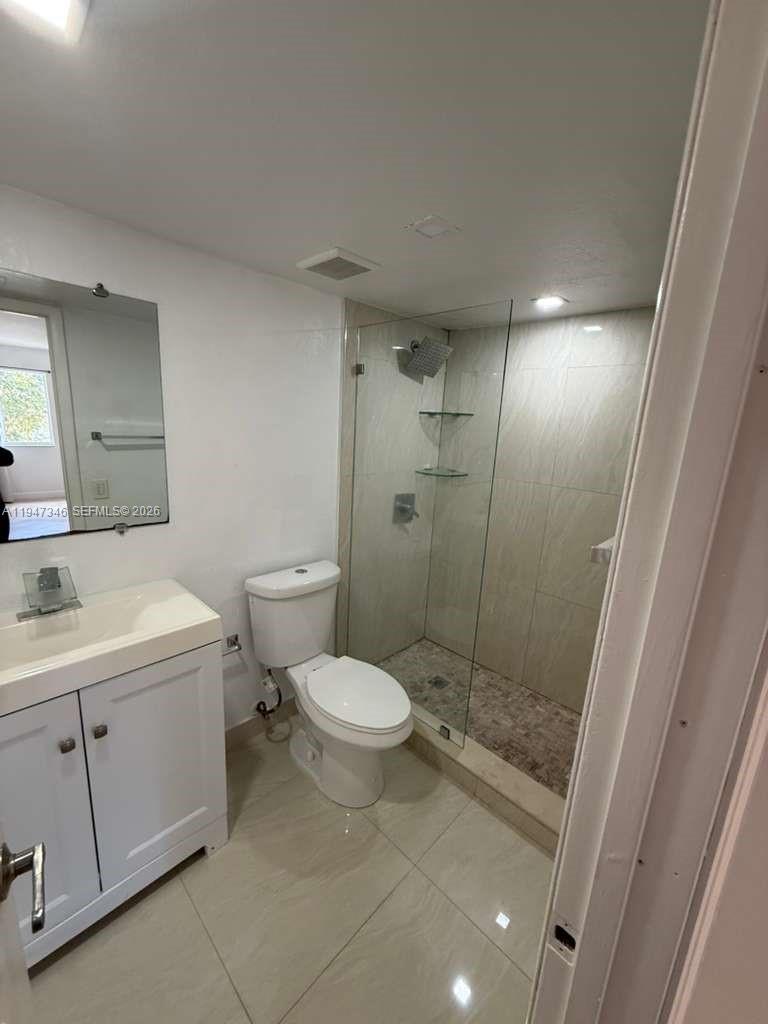15221 Southwest 80th Street, Unit 313 Miami, FL 33193 - Photo 18 of 19 a bathroom with a sink toilet and shower