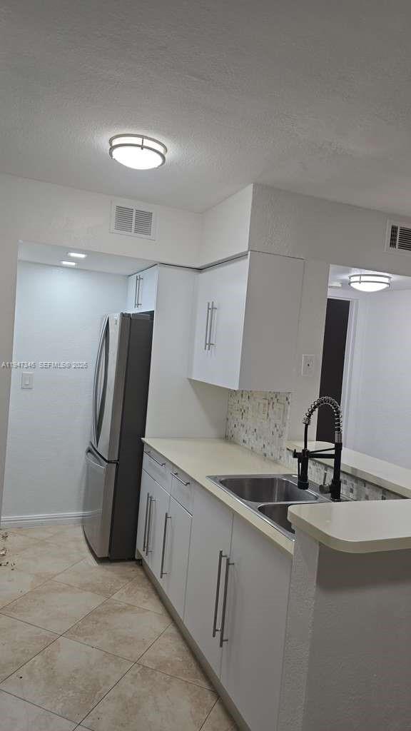 15221 Southwest 80th Street, Unit 313 Miami, FL 33193 - Photo 7 of 19 a kitchen with a sink stainless steel appliances and cabinets