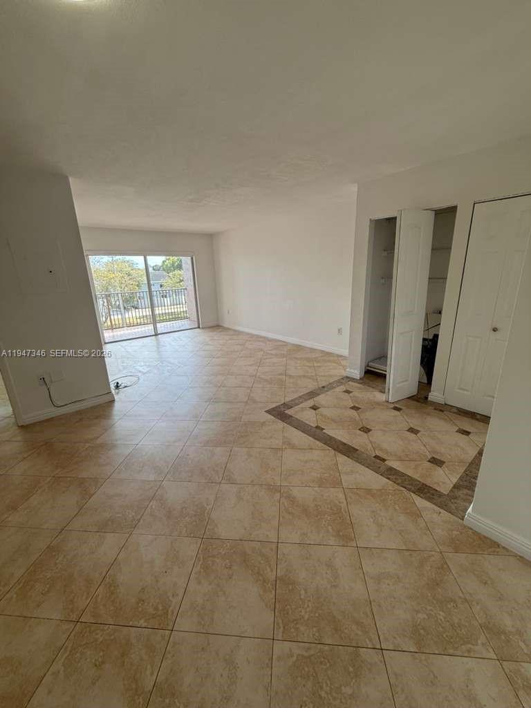 15221 Southwest 80th Street, Unit 313 Miami, FL 33193 - Photo 10 of 19 a view of an empty room and window