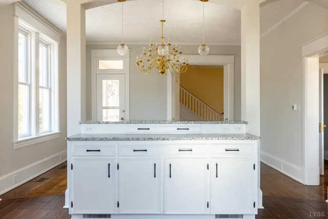 a bathroom with a granite countertop sink a large mirror and a window