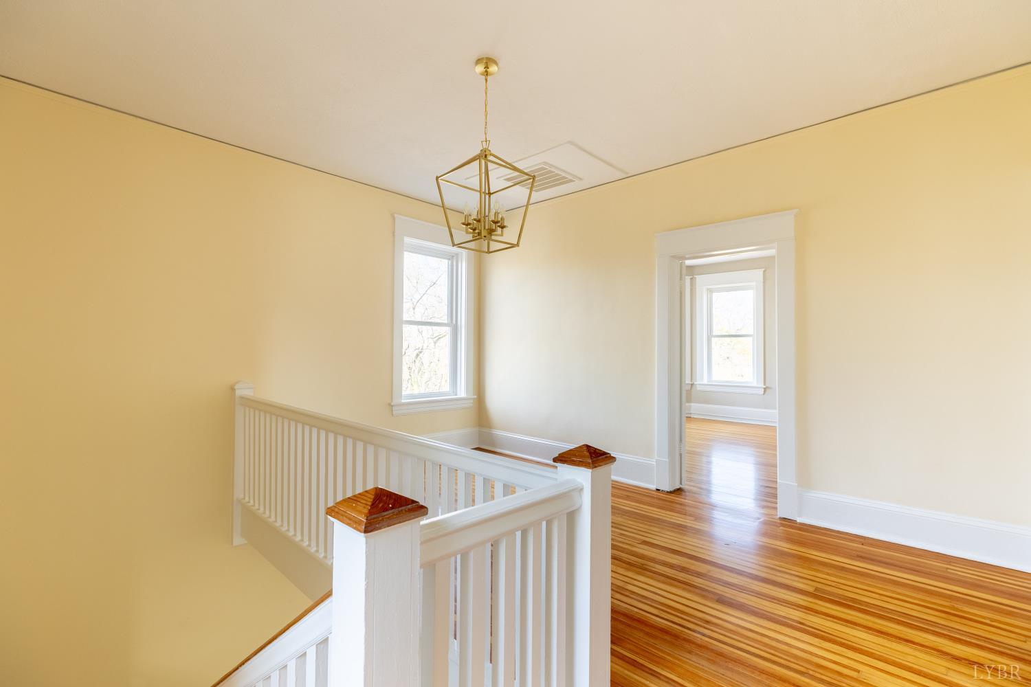 211 Cook Avenue Brookneal, VA 24528 - Photo 21 of 50 a view of a hallway with wooden floor and staircase